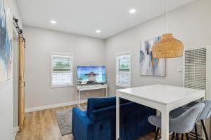 a living room with a white table and a blue couch at West Oceanfront Oasis 4 in Newport Beach