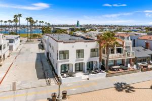 an aerial view of a white building with palm trees at West Oceanfront Oasis 4 in Newport Beach