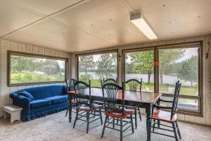 a dining room with a table and chairs and a couch at Rhinelander Vacation Rental with Yard on Venus Lake! in Rhinelander