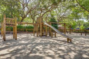 a wooden playground with a slide in a park at Amelia Island Condo with Pool Access Walk to Beach! in Fernandina Beach