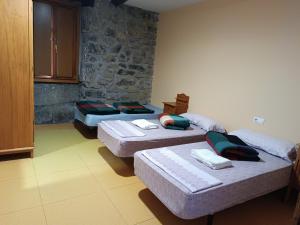 a room with three beds in a room at Ubilla Aterpetxea in Aulestia