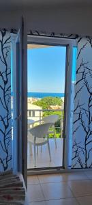a sliding glass door to a patio with a table at Apartmani ARIANA in Dobra Voda