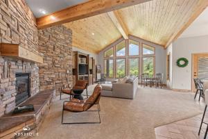 a living room with a stone wall and a fireplace at Private Weber Tributary Access Family Retreat in Morgan Hosted by Nestique in Morgan