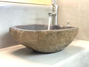a stone sink sitting on a counter in a bathroom at Agia Kyriaki Studios in Agia Kiriaki Beach