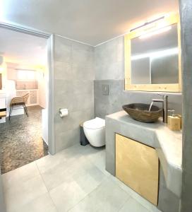 a bathroom with a sink and a toilet at Agia Kyriaki Studios in Agia Kiriaki Beach