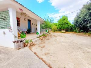 a house with a dirt driveway in front of it at Casina La Tajata in Manduria