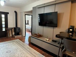 a living room with a flat screen tv on the wall at Bombinhas in Bombinhas