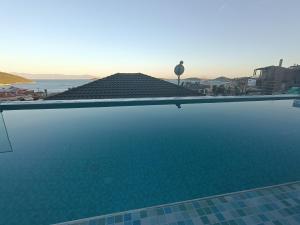 a swimming pool with a view of the ocean at ALTA MARE in Nea Peramos