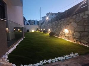 a garden with rocks on the side of a building at ALTA MARE in Nea Peramos