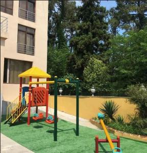a playground in front of a building at Апартаменты с кухней и номера с удобствами у моря in K'obulet'i
