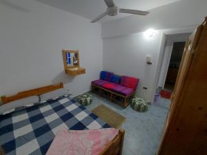 A bed or beds in a room at Anglo Chalets - Ageeba beach