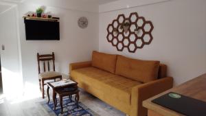 a living room with a couch and a table at Pyramid Gardens in Visoko