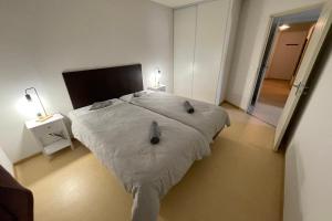 a bedroom with a bed with a white comforter at Les Naïades C14 - 2 bedrooms for 6 people ! in Avène +18 photos