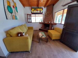 a living room with a yellow couch and a table at Barranca de la Luna in Tafí del Valle