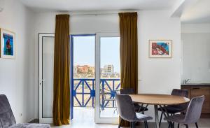 a dining room with a table and chairs and a balcony at Casa Branca Beach in Santa Maria