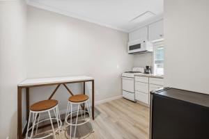 a kitchen with a counter and two stools in it at 1628 West Oceanfront Oasis 6 in Newport Beach