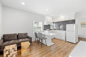 a living room with a couch and a kitchen at 1628 West Oceanfront Oasis 8 in Newport Beach
