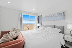 a bedroom with a large bed and a window at 1628 West Oceanfront Oasis 8 in Newport Beach