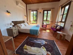 a bedroom with a bed and a living room at Çirkince Konak Şirince in Selçuk