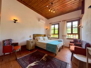 a bedroom with a bed in a room with windows at Çirkince Konak Şirince in Selçuk