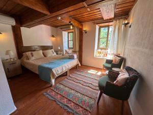 a bedroom with a bed and a couch and a chair at Çirkince Konak Şirince in Selçuk