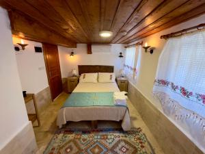 a bedroom with a bed and a rug in a room at Çirkince Konak Şirince in Selçuk +38 photos