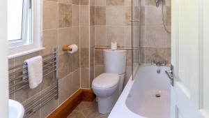 ein Badezimmer mit Toilette, Badewanne und Waschbecken in der Unterkunft Ta Mill Cottages & Lodges - Meadowview Chalet 2 in Launceston + 27 Fotos