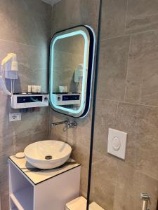 a bathroom with a sink and a mirror at Chalet Ambel in Dhërmi