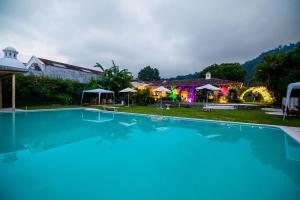 a large swimming pool in front of a house at Yes Please! Hostel in Antigua Guatemala