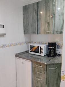 a microwave sitting on a counter in a kitchen at M&Mcies in Baiona +8 photos