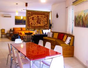 a living room with a table and a couch at Villa Balluta in St Julian's +10 photos