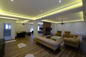 a living room with two couches and a tv at Bala apartment in Tirana