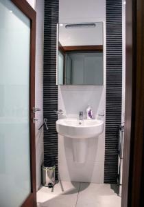 a bathroom with a sink and a mirror at Villa Balluta in St Julian's