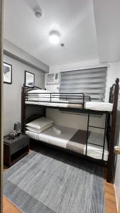 two bunk beds in a room with a rug at Urban Charms Seawind Condo, 5 mins to Davao Int'l Airport and Wharf to Samal Beach in Davao City +14 photos