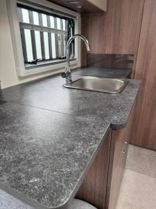 a kitchen counter with a sink and a window at Tayys Inn Luxury Camp in Birmingham +14 photos