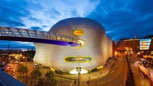 a building in a city at night with at Tayys Inn Luxury Camp in Birmingham