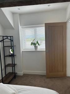 a bedroom with a door and a plant in a window at Bay View House in Bangor +49 photos