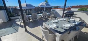 a table and chairs on top of a balcony at Vila Ibrahimovic Vodice in Vodice