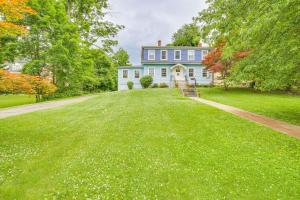 a large yard in front of a blue house at Historic Poughkeepsie Home Near Arlington & Vassar in Poughkeepsie