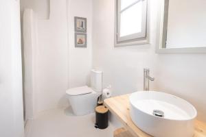 a bathroom with a white toilet and a sink at SWELL S6 new studio in Naousa in Naousa