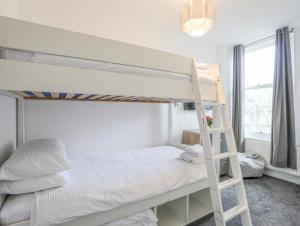 a bedroom with two bunk beds and a ladder at Bodafon View in Llandudno