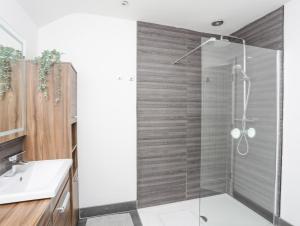 a bathroom with a shower and a sink at Bodafon View in Llandudno +22 photos