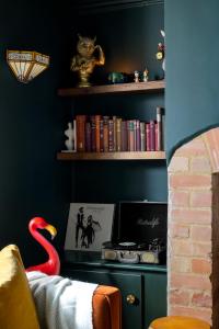a room with a book shelf with books and a swan at Chipping Campden Shabby Chic on Famous High Street in Chipping Campden +46 photos