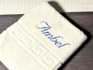 a white napkin with the wordarma written on it at Chalet Ambel in Dhërmi