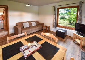 a living room with a couch and a table at Ta Mill Cottages & Lodges - Brookview Lodge 3 in Launceston