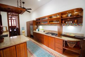 a large kitchen with wooden cabinets and a counter top at Casa Castilla in Santa Marta