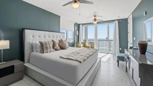 a bedroom with a large white bed and a balcony at Bali Bay Resort in Myrtle Beach +89 photos