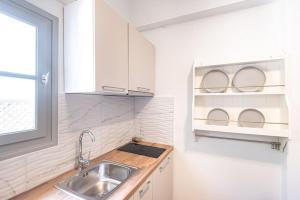 a small kitchen with a sink and a window at Swell S7 new 2 bd flat in Naousa in Naousa
