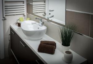 a bathroom with a white sink and a mirror at Apartment Admiral in Belgrade +22 photos