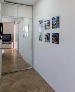 a room with a sliding glass door and pictures on the wall at Apartment Admiral in Belgrade